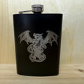 Black flask with dragon design on a wooden surface