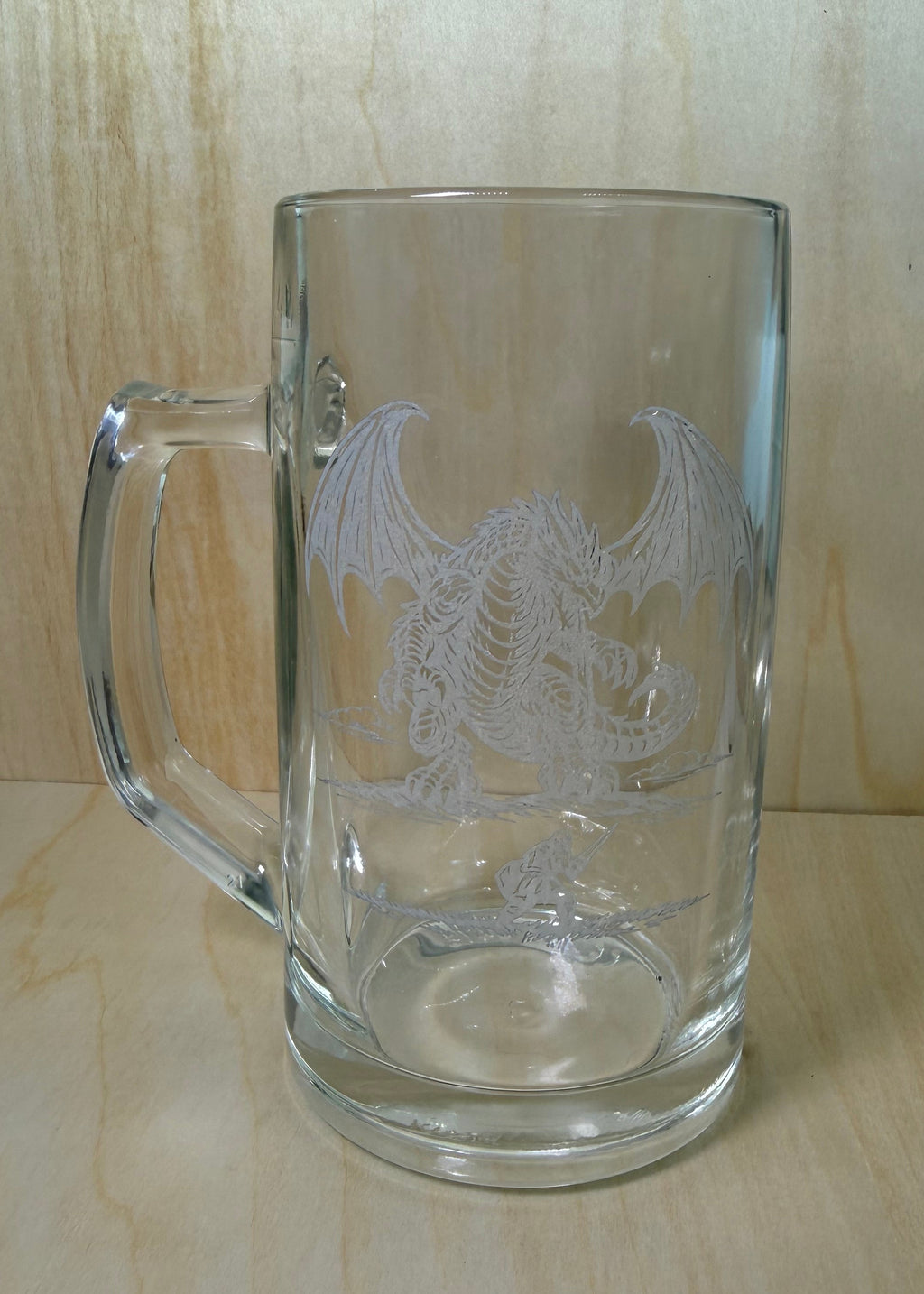 Clear glass mug with handle on a wooden surface