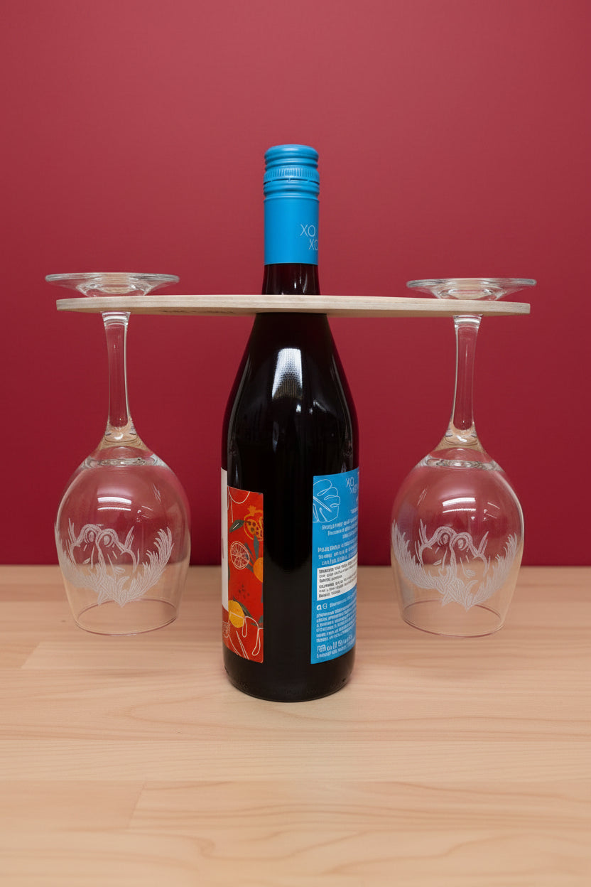 Wine bottle with blue label and two wine glasses on a wooden surface